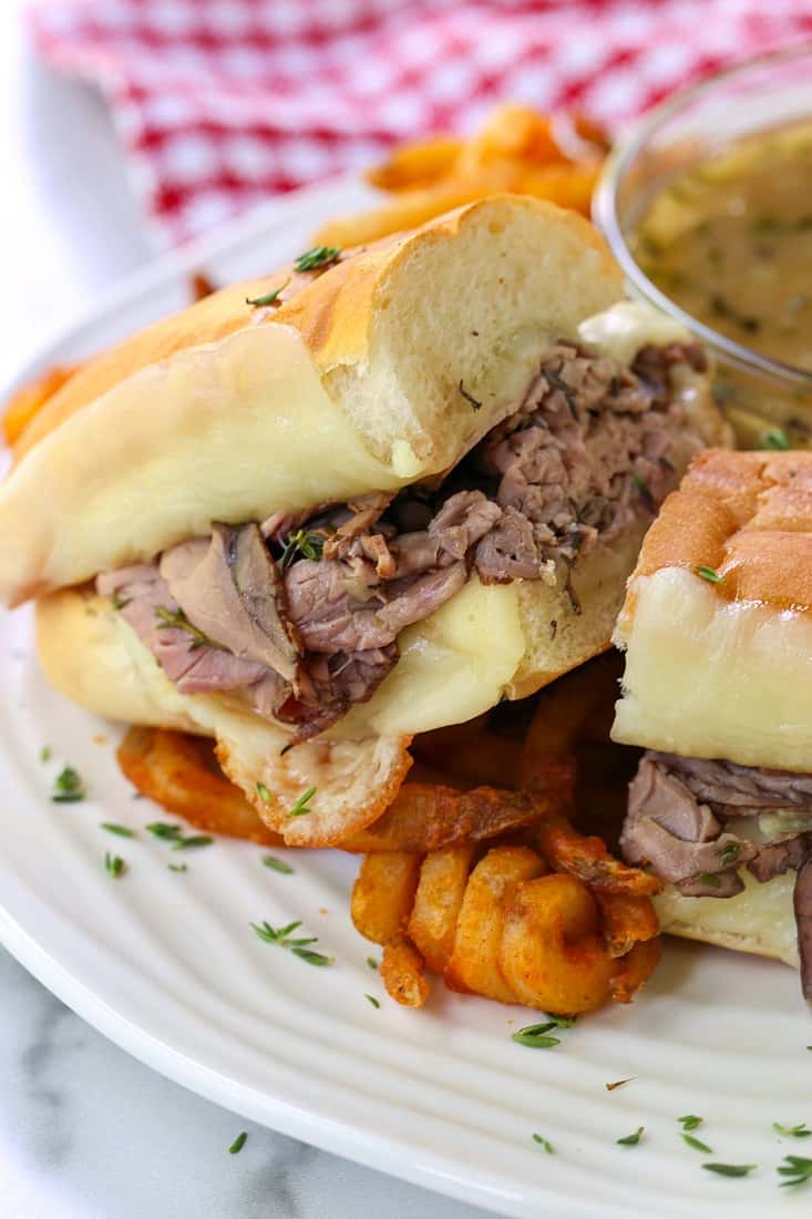 French Dip Sandwich cut on plate with fries