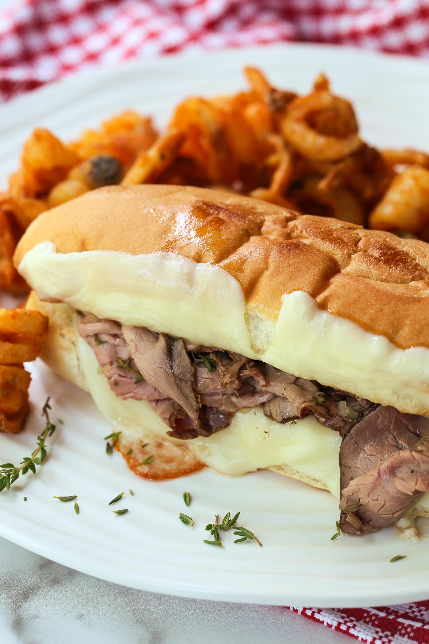 roast beef sandwich with french fries on a plate