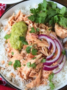 shredded salsa chicken over rice with onions and guacamole
