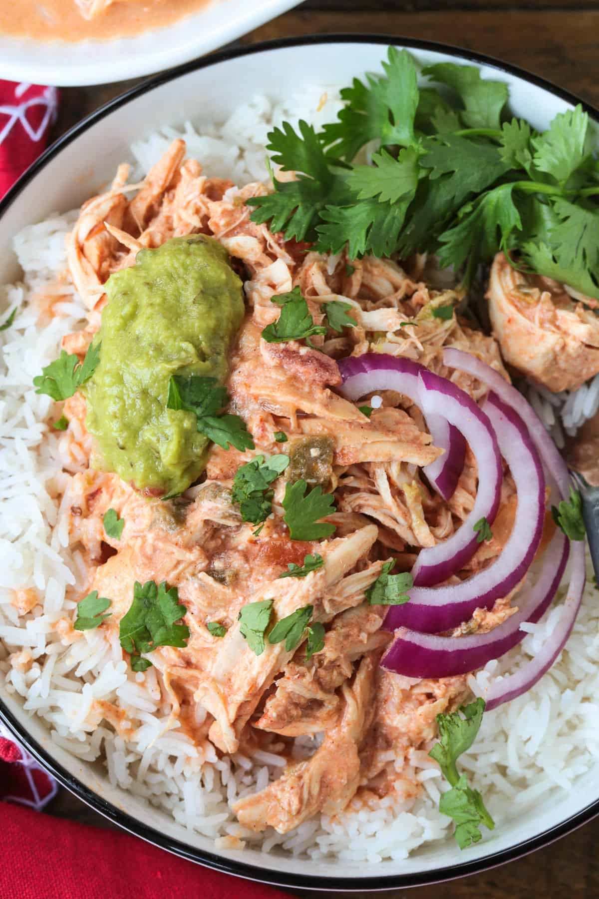 shredded salsa chicken over rice with onions and guacamole