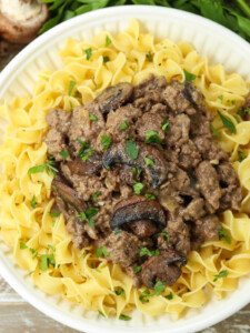 ground beef stroganoff over noodles on plate