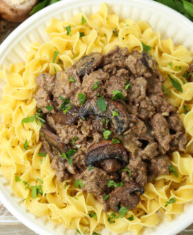 ground beef stroganoff over noodles on plate