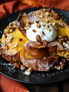 French toast casserole with whipped cream and pecans
