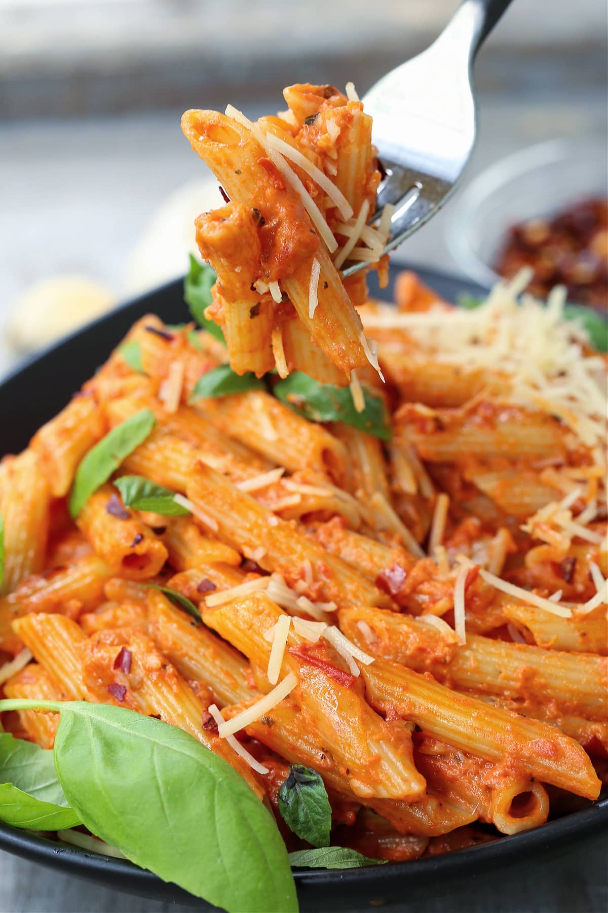 penne alla vodka in a bowl with a fork full of pasta