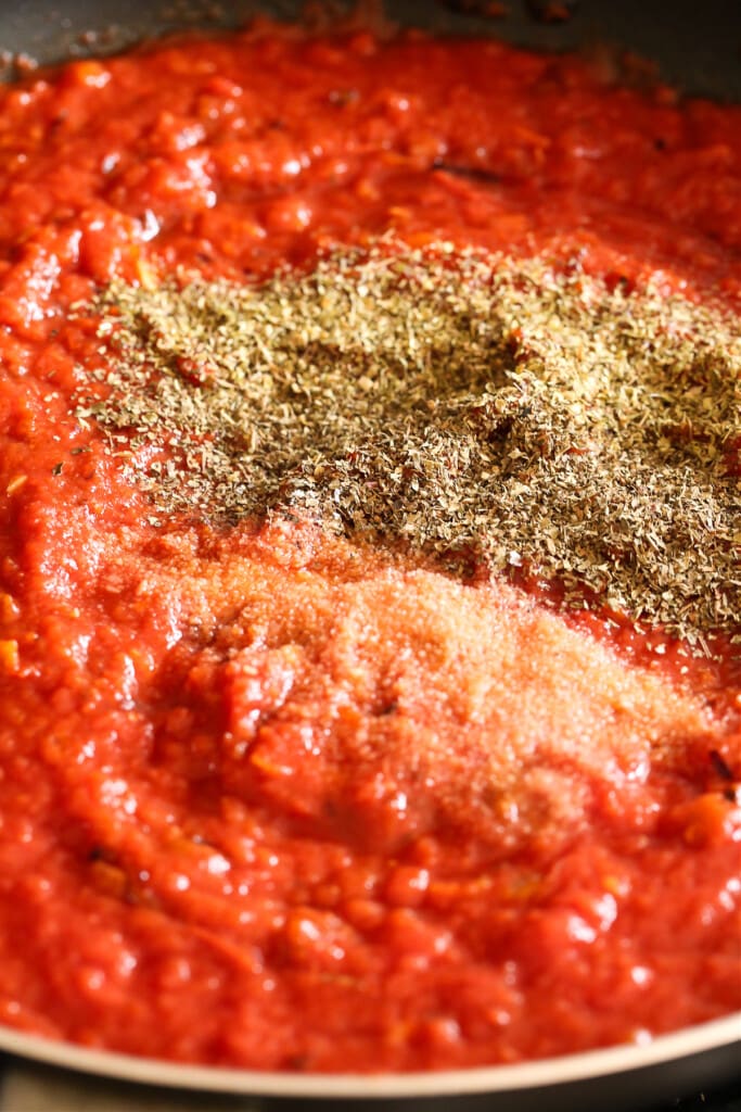 crushed tomatoes, dried oregano and salt in a skillet