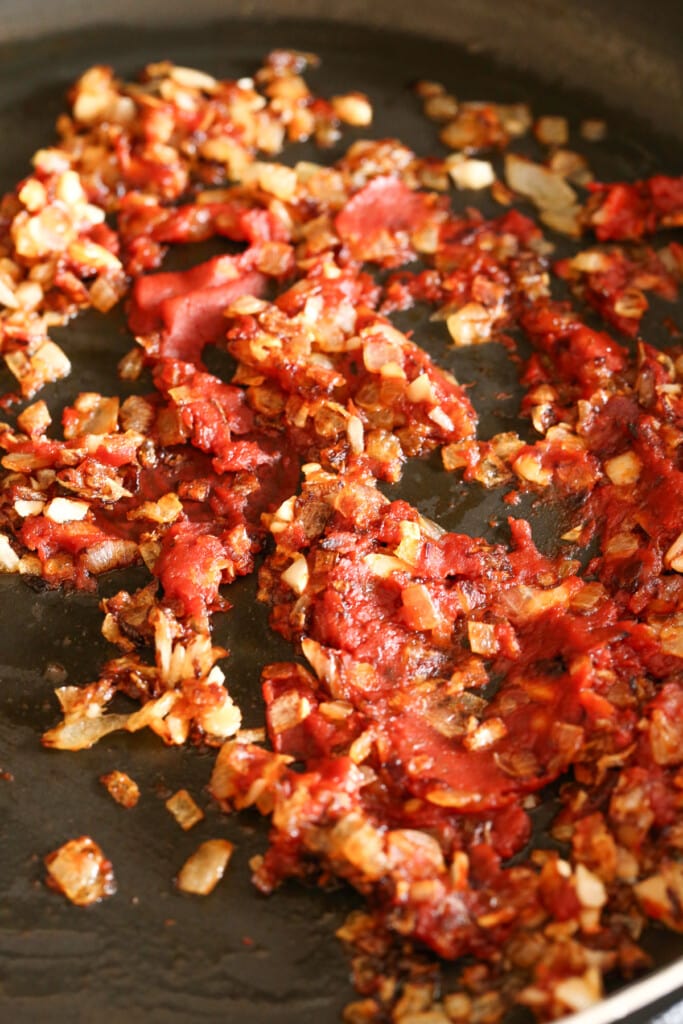 cooked onions and tomato paste in a skillet