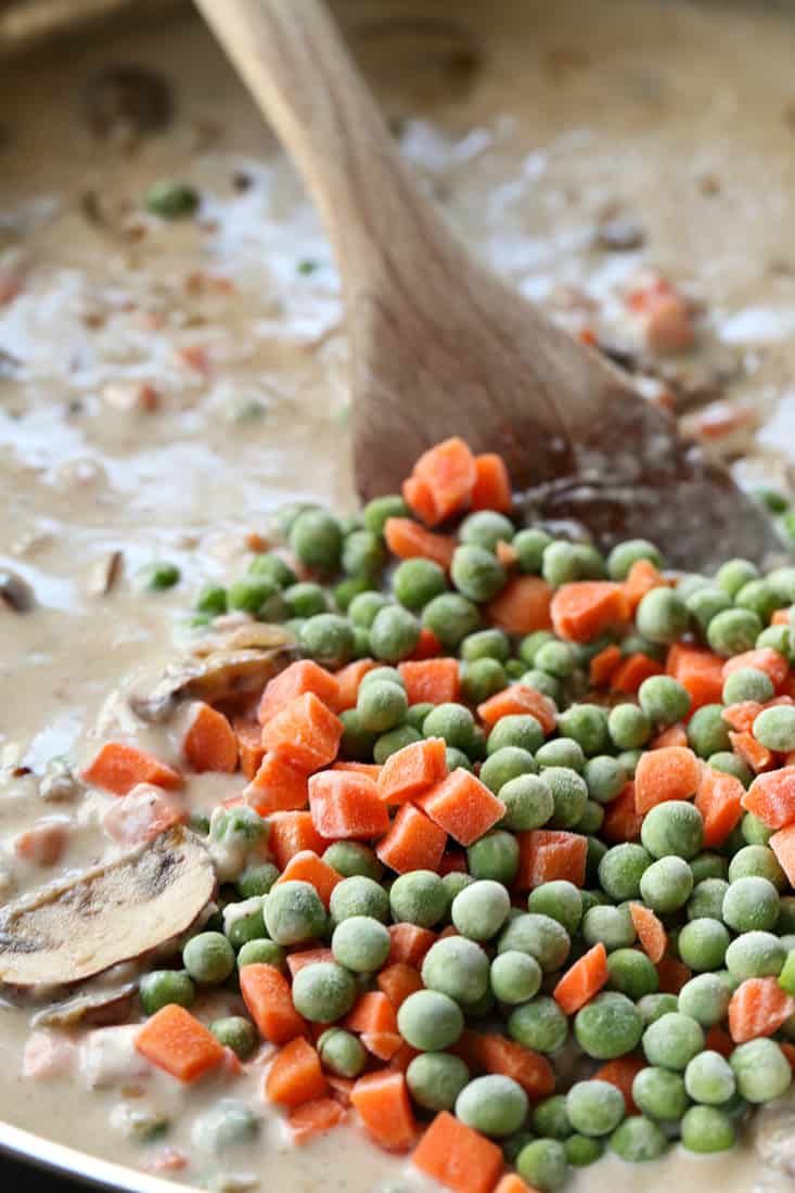 frozen peas and carrots added to creamy tuna casserole filling