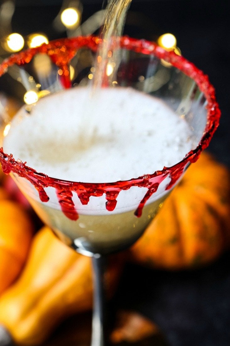 Champagne pouring into glass for Halloween drink recipe