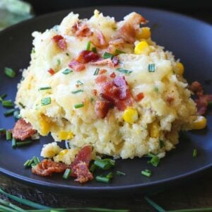 Bacon Corn Spoon Bread recipe served on a black plate