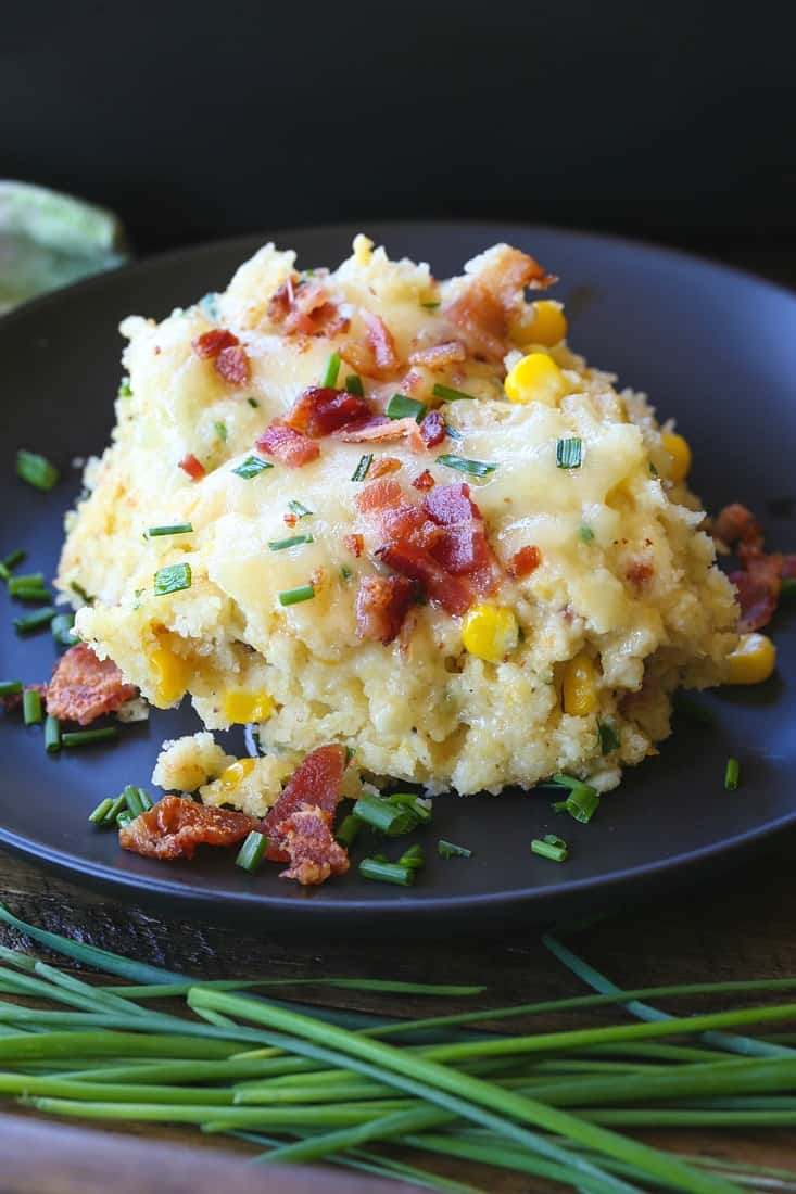 Bacon Corn Spoon Bread recipe served on a black plate