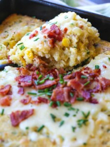 Spoon bread with bacon and cheese on a serving spoon