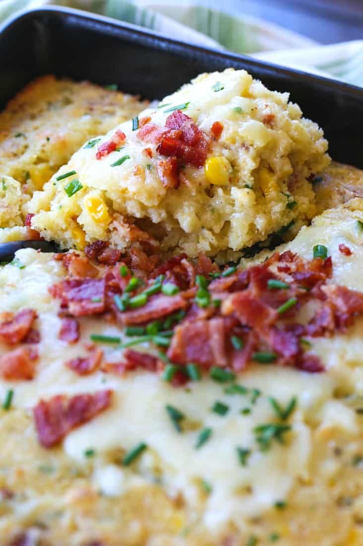 Spoon bread with bacon and cheese on a serving spoon