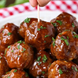 hand grabbing a meatball with a toothpick