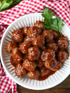 bbq meatballs in white bowl with checkered napkin