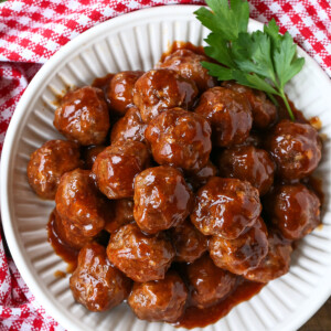 bbq meatballs in white bowl with checkered napkin