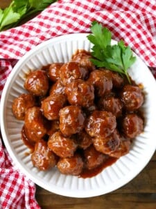 cocktail meatball recipe in a white bowl with parlsey