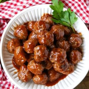 cocktail meatball recipe in a white bowl with parlsey