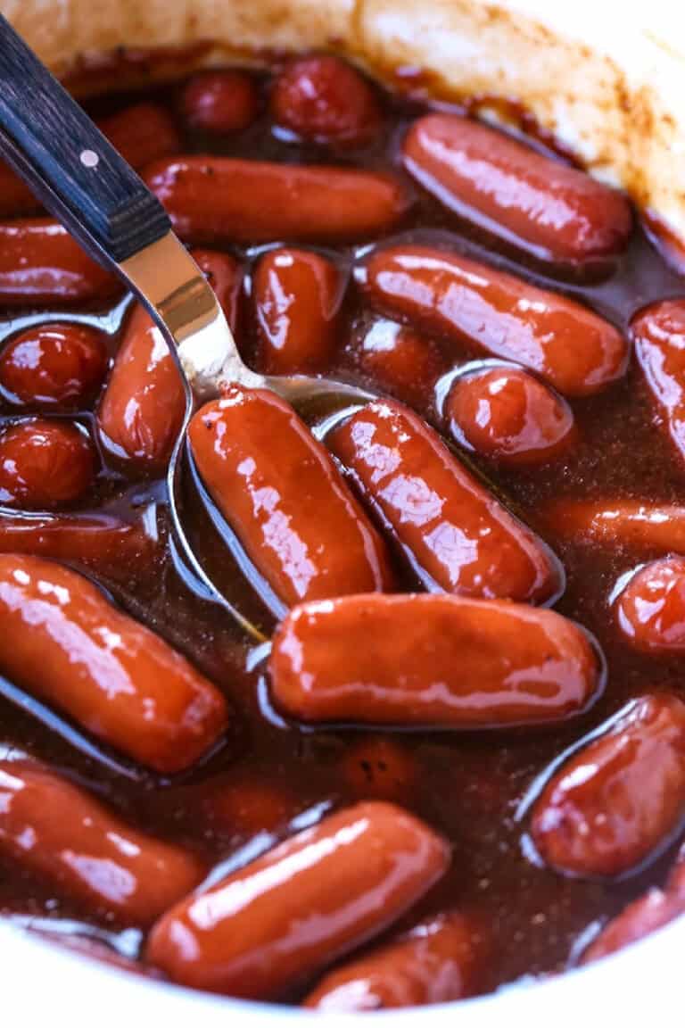 Spoon in a slow cooker with saucy little smokies