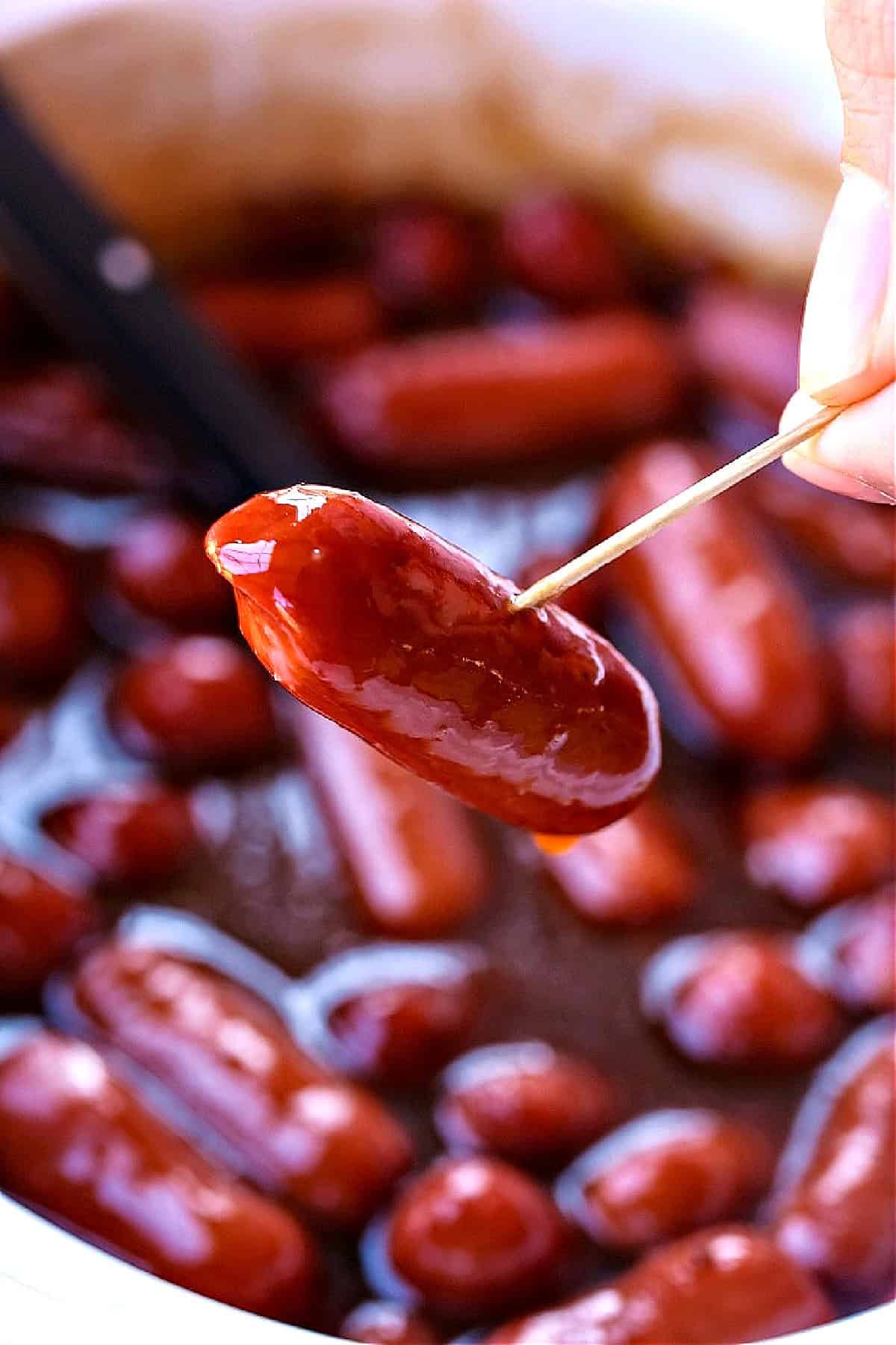 little smokies in a crock pot with one on a toothpick