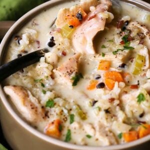 Turkey and rice soup with vegetables on a spoon