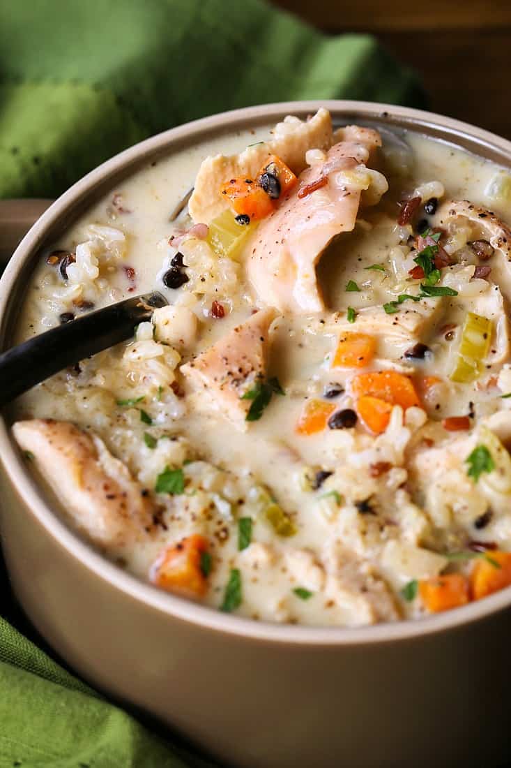 Turkey and rice soup with vegetables on a spoon