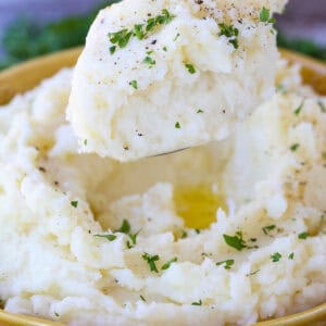 spoonful of mashed potatoes over bowl