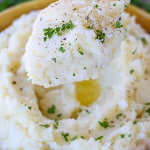 mashed potatoes on spoon with thyme