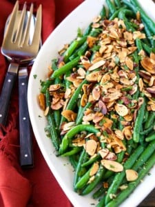 green beans almondine on a white platter