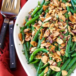 green beans almondine on a white platter