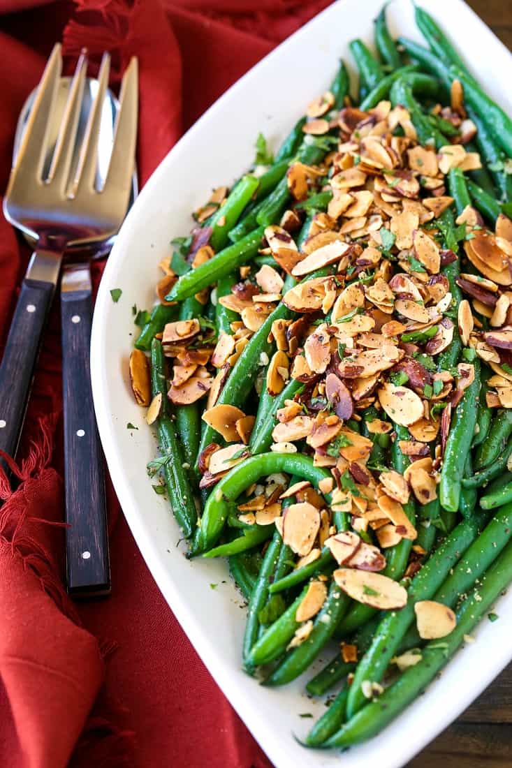 green beans almondine on a white platter