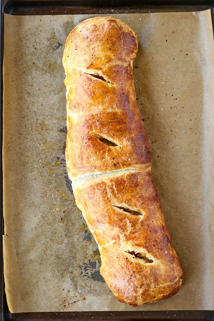 Sausage strudel recipe on a baking sheet