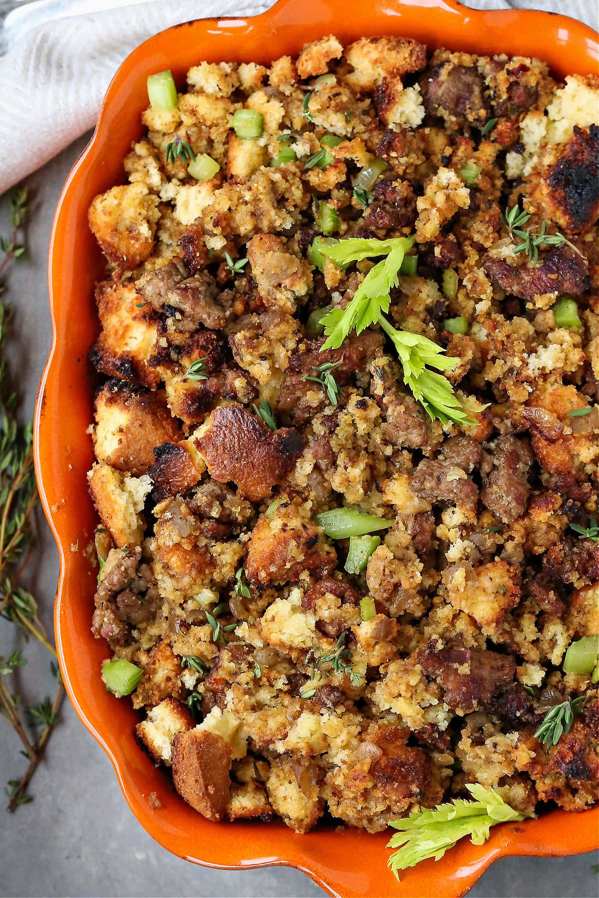 cornbread dressing with sausage in orange baking dish