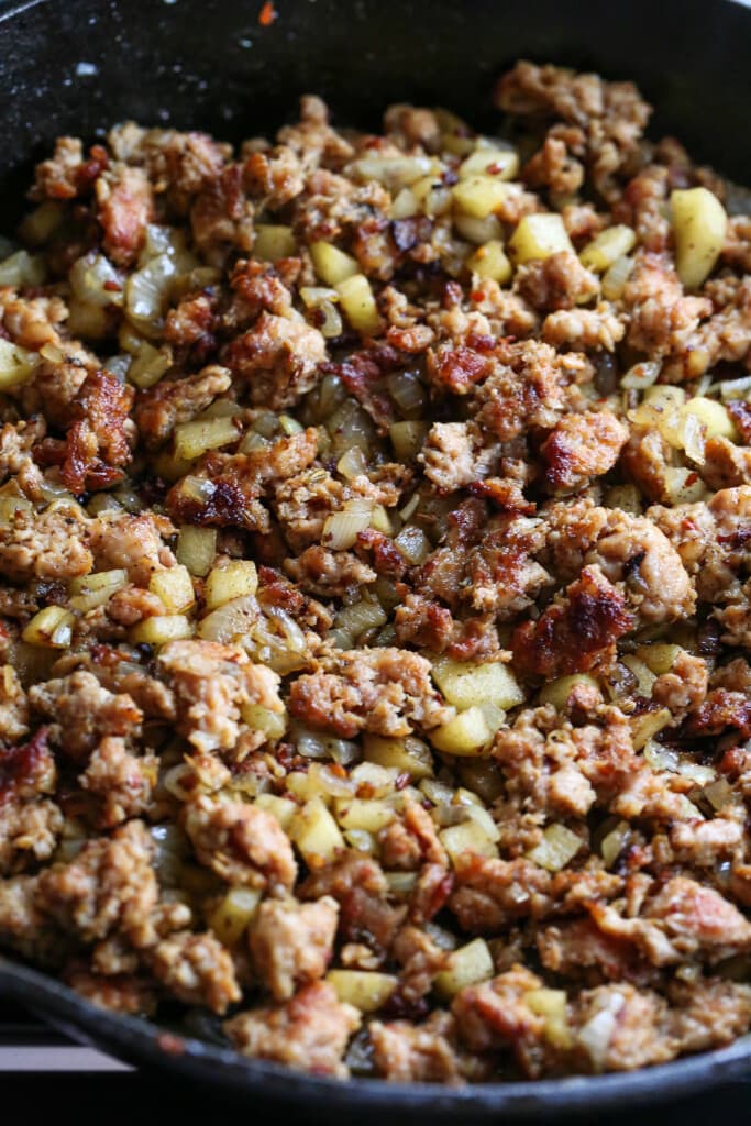 crumbled sausage in skillet with onions and celery