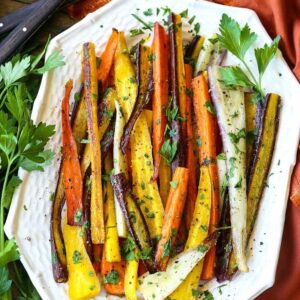 Roasted carrots with parsley on a white platter