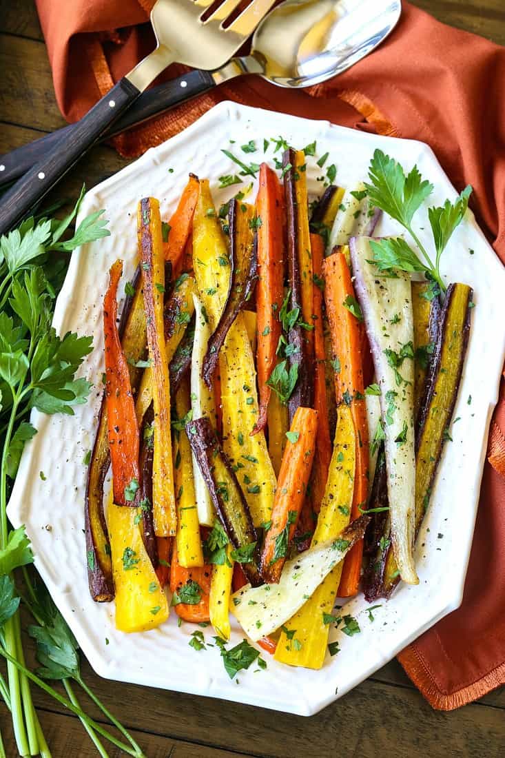 Roasted carrots with parsley on a white platter
