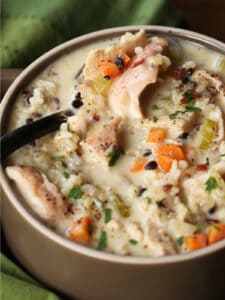 spoon in bowl of turkey soup with rice and vegetables