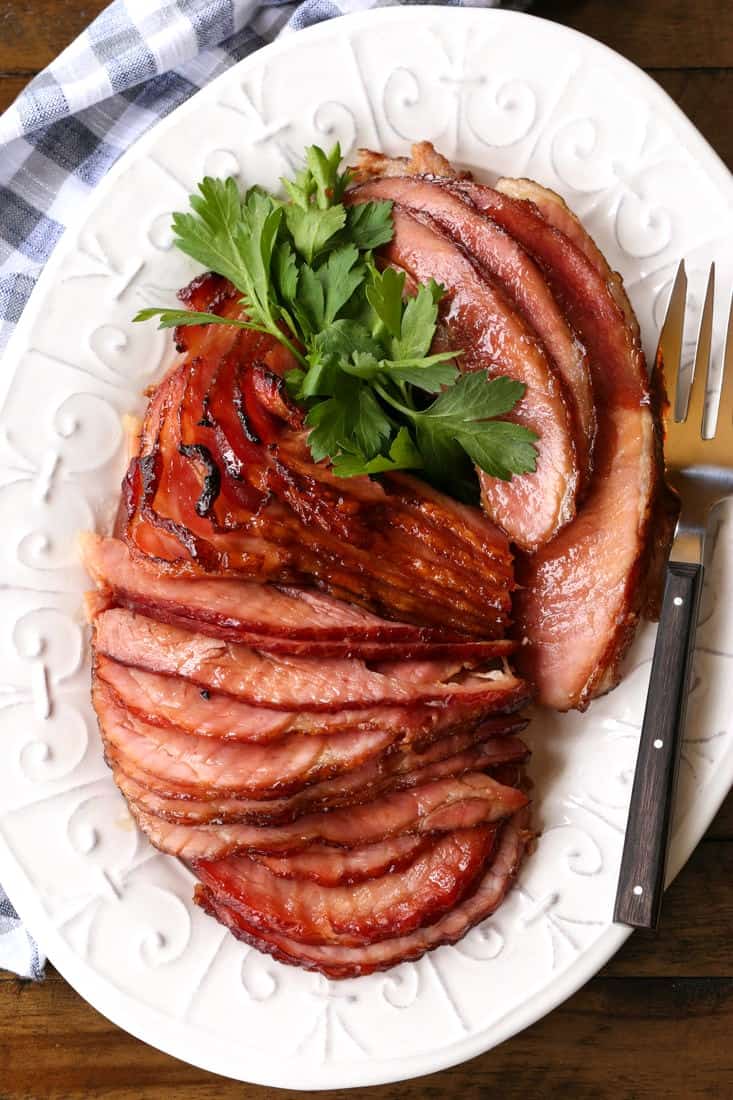 spiral sliced ham on a platter with fork