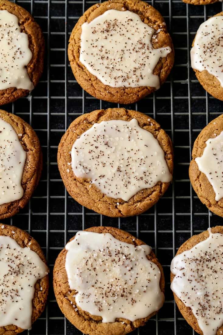 Bourbon Iced Molasses Cookies are going to be the star of your dessert table! A bourbon infused icing makes these cookies a party favorite! Iced Molasses Cookies on a baking rack