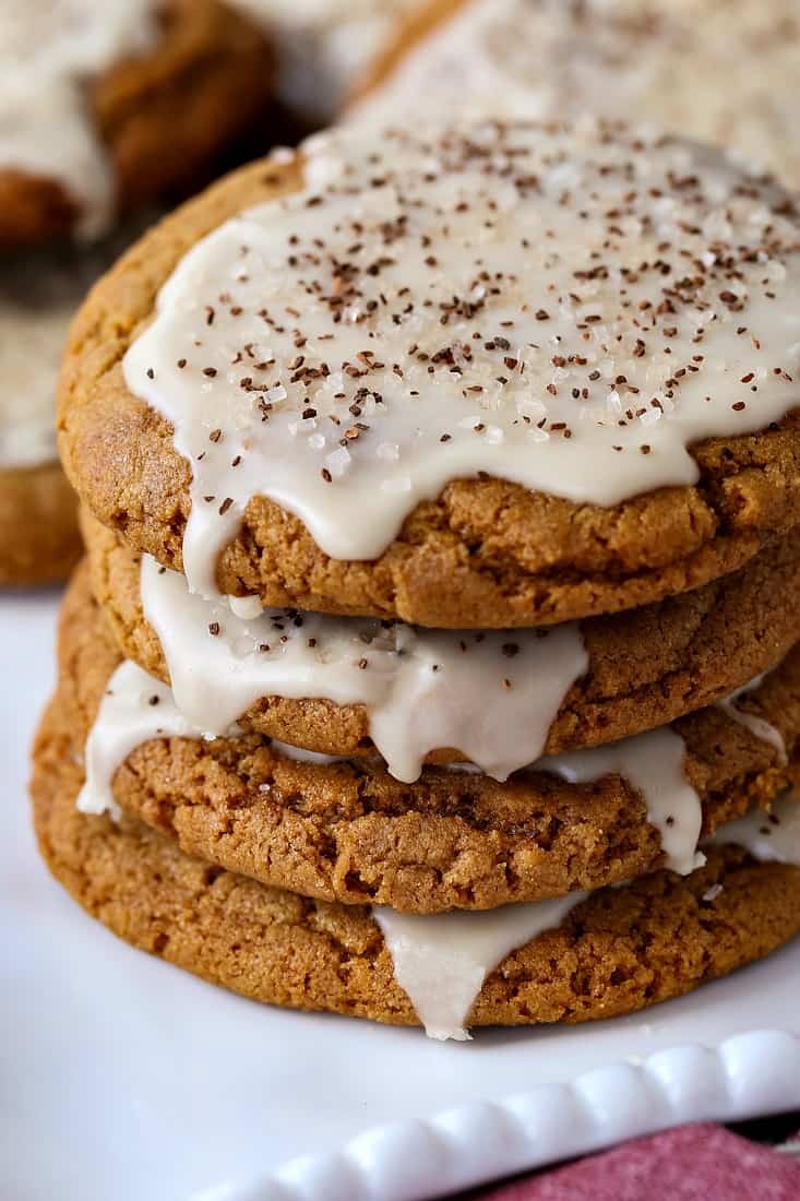 Bourbon Iced Molasses Cookies are going to be the star of your dessert table! A bourbon infused icing makes these cookies a party favorite! Bourbon Molasses Cookies stacked on a platter