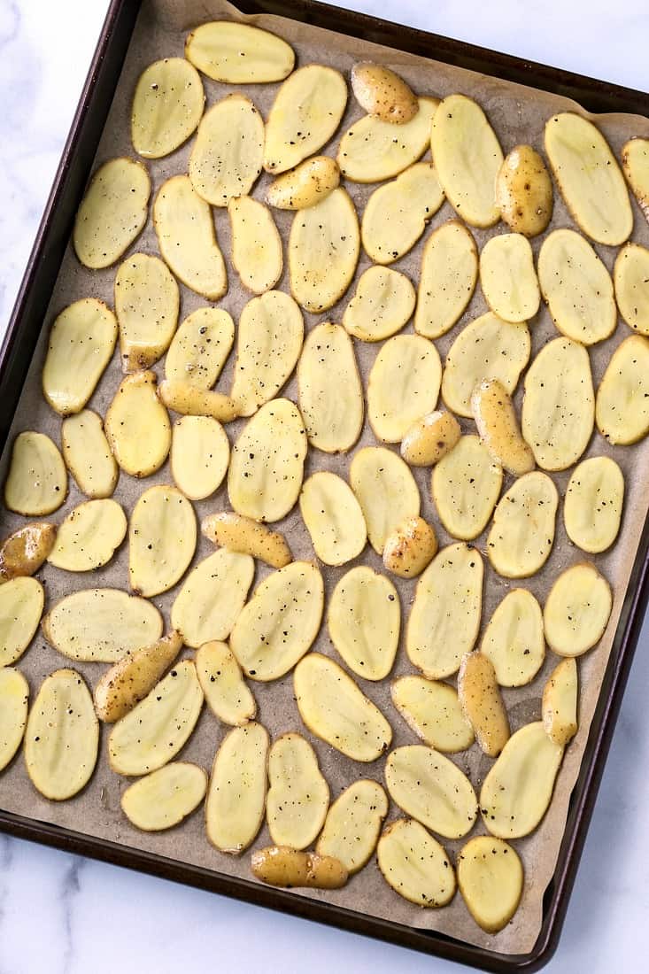 sliced fingerling potatoes on a baking sheet