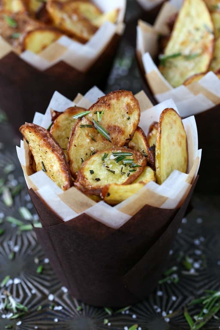Roasted fingerling potatoes in paper cups with fresh roasemary
