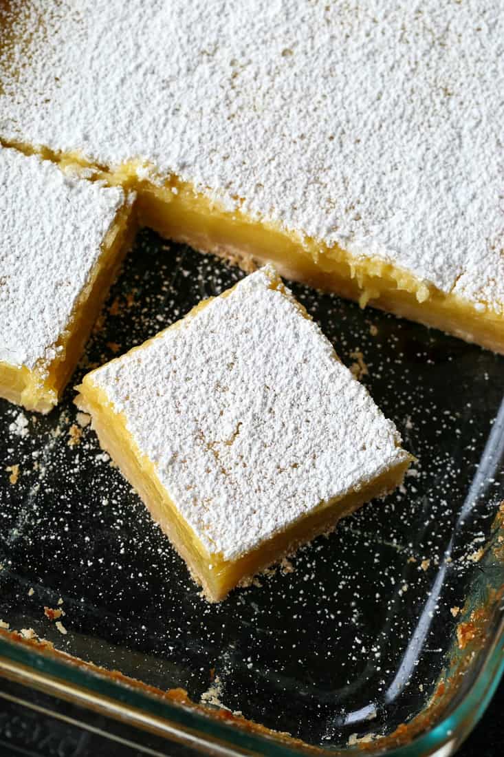 lemon bars cut in a baking dish