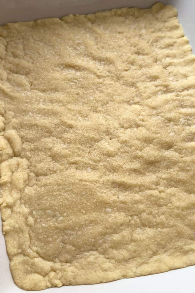 Our Limoncello Lemon Bars are a fun party dessert! Zesty lemon bars with a thick, buttery shortbread topped with a sweet and creamy custard. shortbread crust after baking