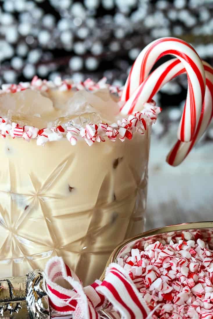 Cocktail in a low ball glass with candy canes for garnish