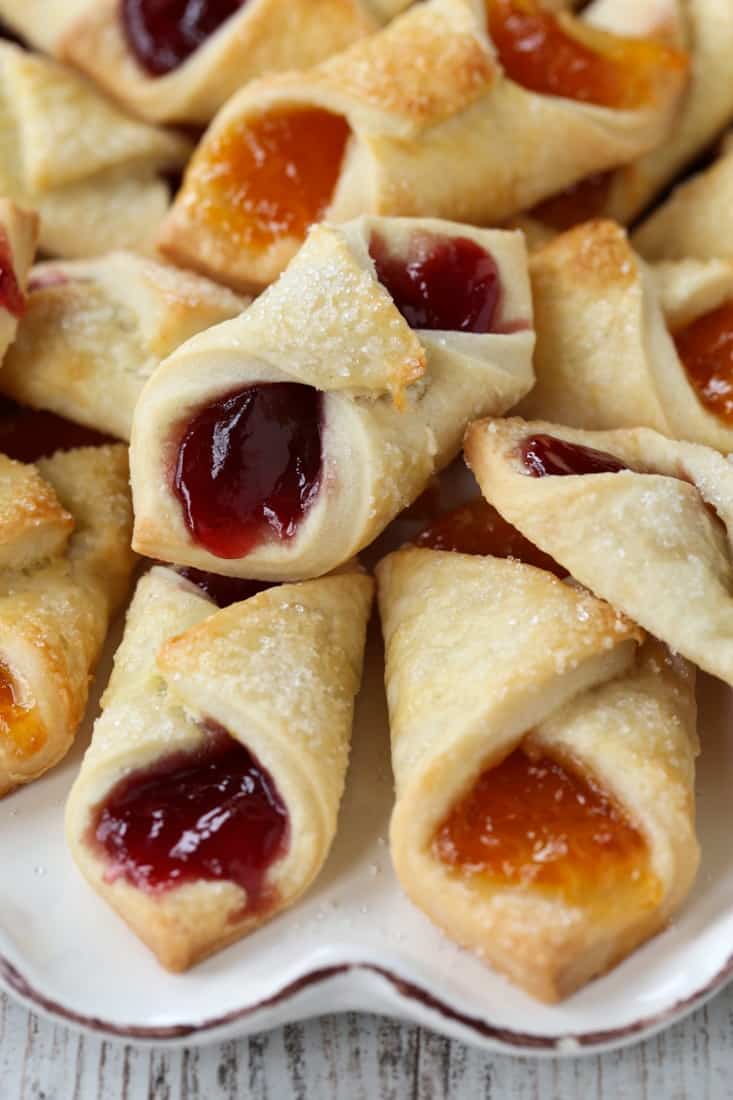 Golden-brown Polish Cream Cheese Cookies filled with bright red and yellow jelly.