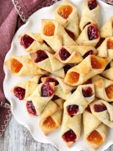 Polish Cream Cheese Cookies filled with jelly on a white plate.