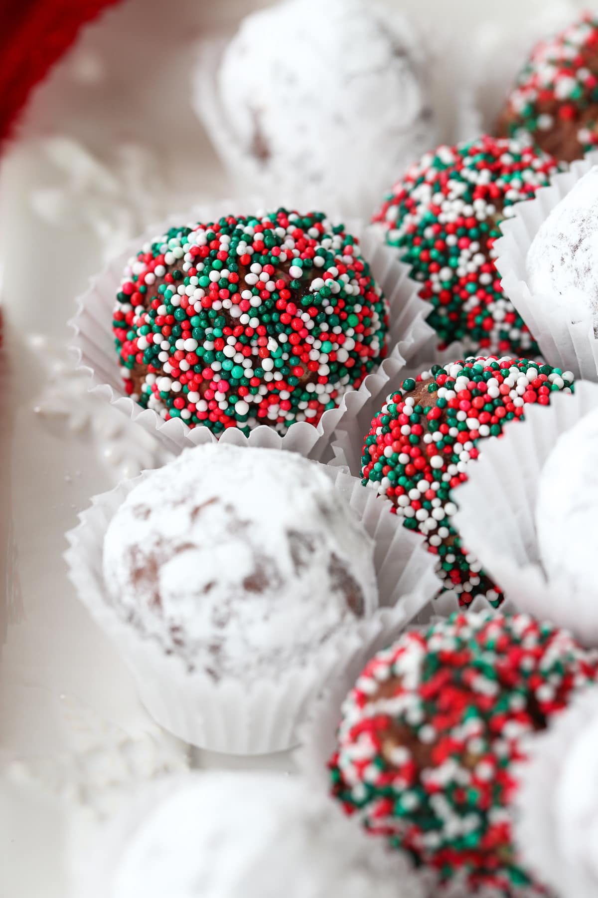 rum balls decorated on white snowflake platter