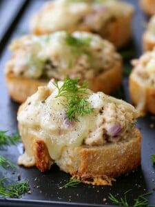 mini tuna melts on black platter with fresh dill