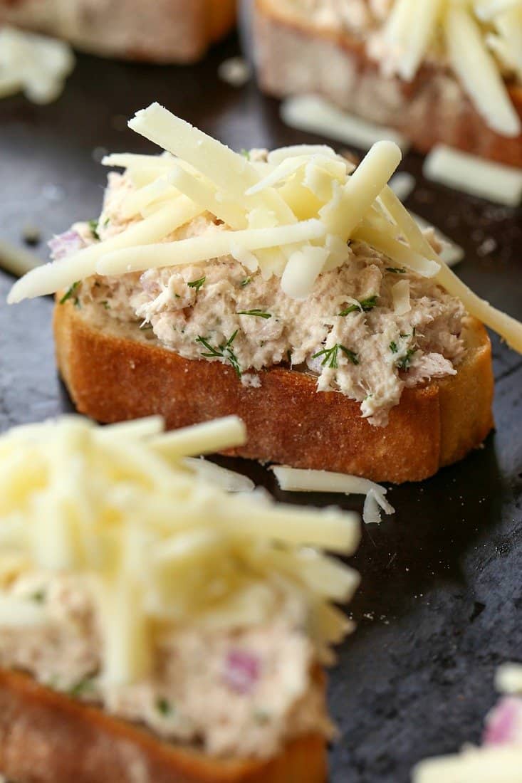 tuna salad with cheese on a slice of bread before baking