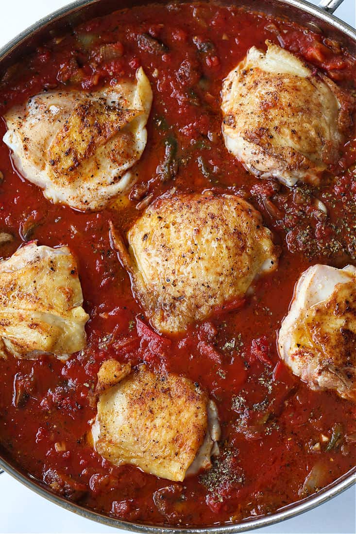 Chicken thigh recipe in tomato sauce with peppers and mushrooms 